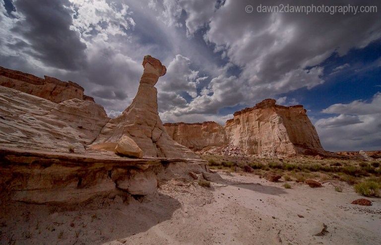 Sandstone walls and hoodoos carved through erosion make up the landscape at Wahweap Creek near Big Water, Utah