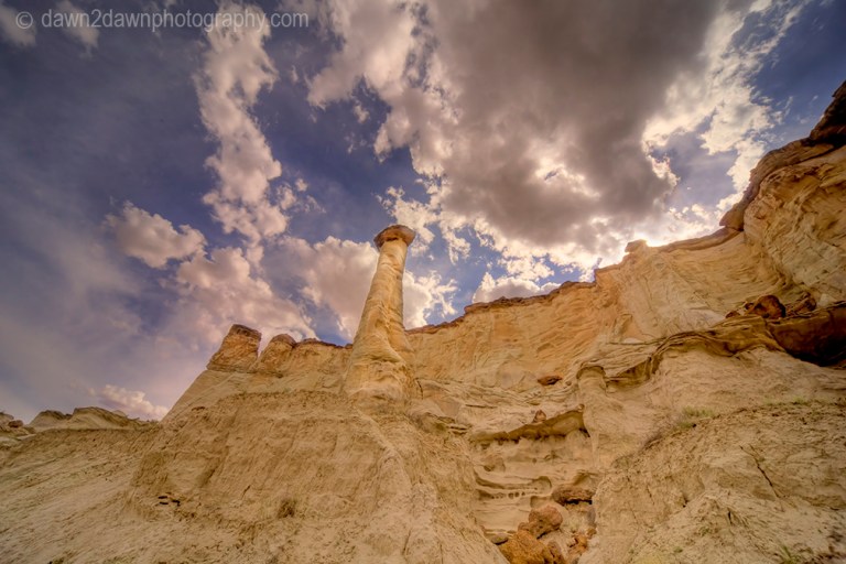 Sandstone walls and hoodoos carved through erosion make up the landscape at Wahweap Creek near Big Water, Utah