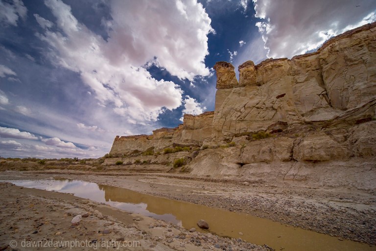 Sandstone walls and hoodoos carved through erosion make up the landscape at Wahweap Creek near Big Water, Utah