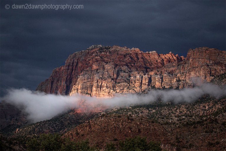 Passing storms bring rain and fog to the steep sandstone canyon walls at Zion National Park, Utah