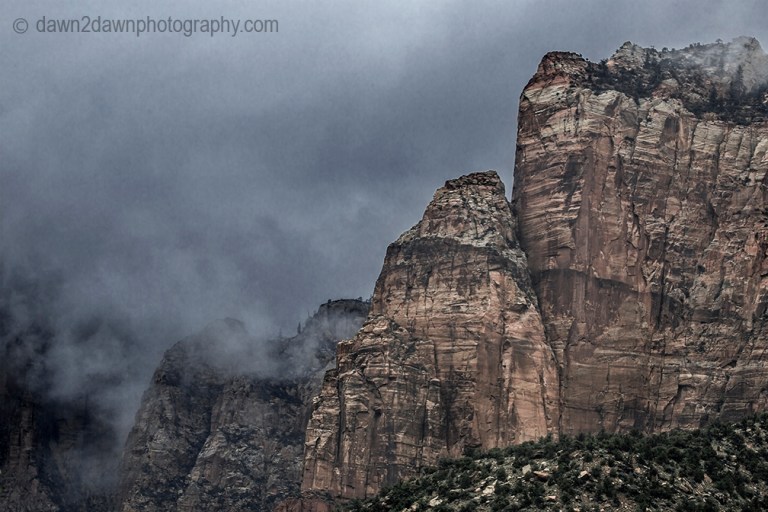 Passing storms bring rain and fog to the steep sandstone canyon walls at Zion National Park, Utah