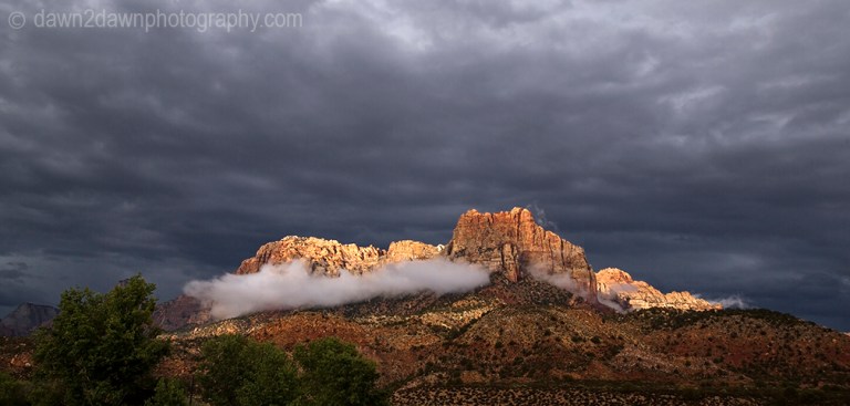 Passing storms bring rain and fog to the steep sandstone canyon walls at Zion National Park, Utah