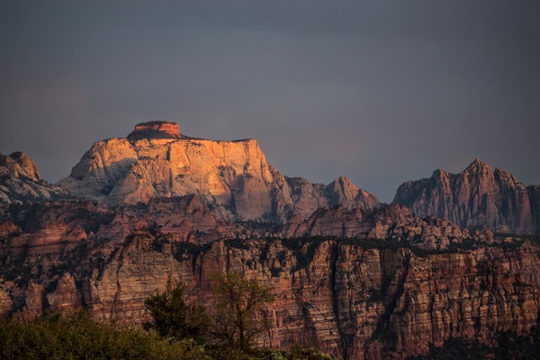 The sun sets on the West Temple as seen from Kolob Terrace at Zion National Park, Utah