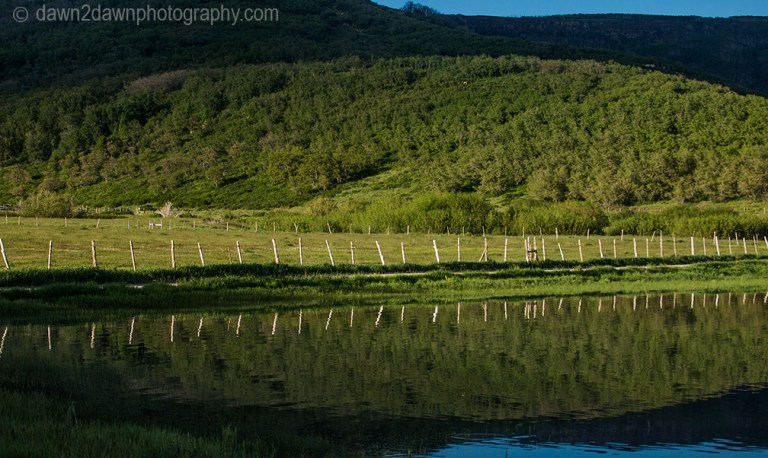 The surrounding landscape is reflected in the waters of Kolob Reservoir near Zion National Park, Utah