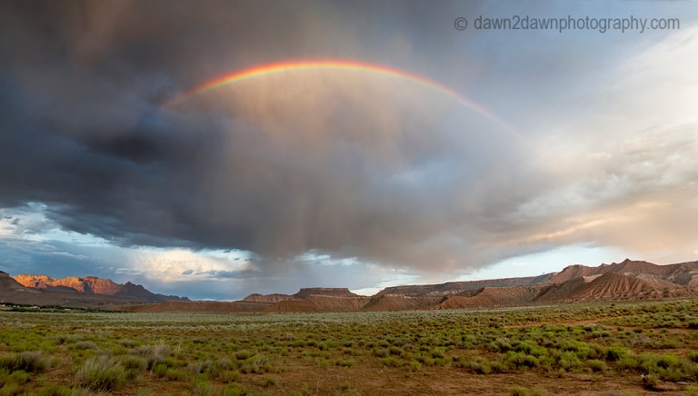 A thunderstorm passes through Zion Canyon and produces a rainbow at Zion National Park, Utah