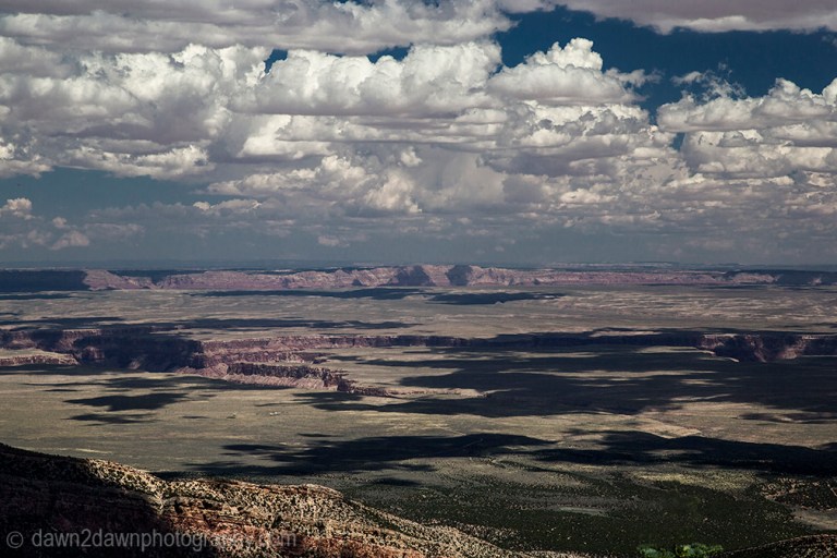 Passing clouds produce shadows on the landscape around Marble Canyon in Northern Arizona