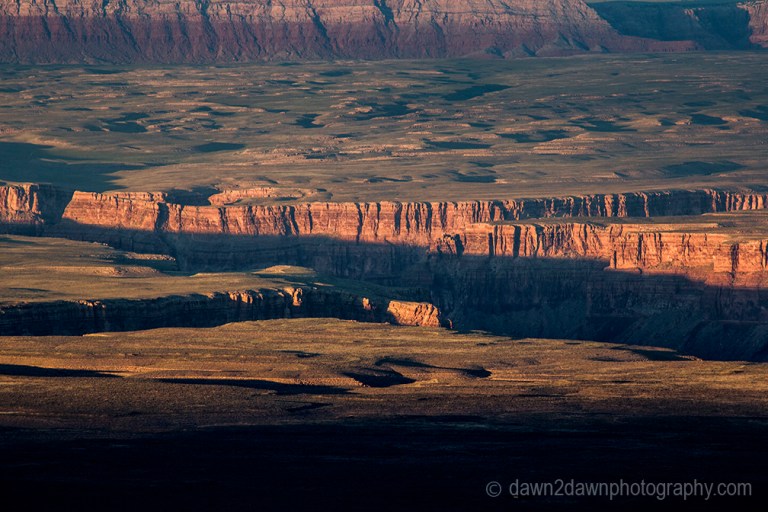 Passing clouds produce shadows on the landscape around Marble Canyon in Northern Arizona