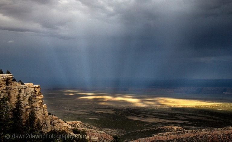 Shafts of light beam down onto the Northern Arizona landscape near the Grand Canyon