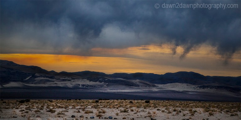 Storm clouds threaten Eureka Valley at sunset at Death Valley National Park, California