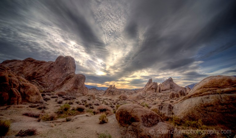 The sun rises over the eroded sandstone rocks of Alabama Hills in the Owens Valley of California