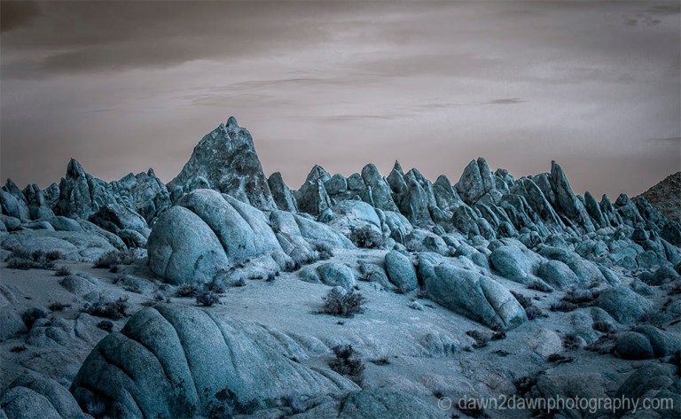 The sun rises over the eroded sandstone rocks of Alabama Hills in the Owens Valley of California