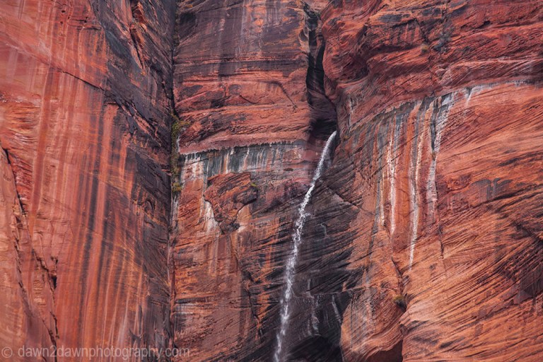 A seasonal waterfall flows from the top of Zion Canyon at Zion National Park, Utah