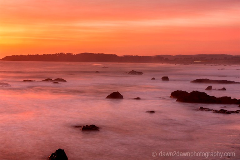 The sun sets over the Pacific Ocean near San Simeon, California