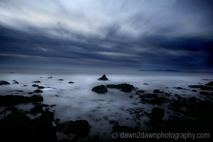 The sun sets over the Pacific Ocean at Cambria, California