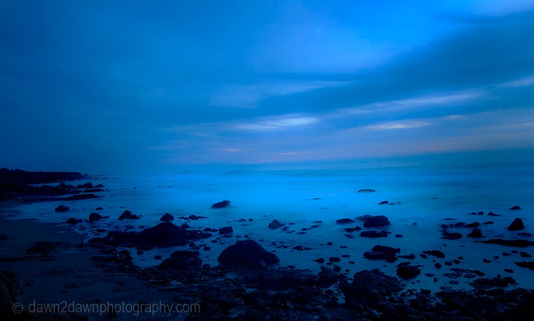 The sun sets over the Pacific Ocean at Cambria, California