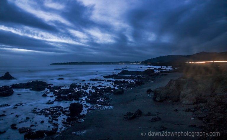 The sun sets over the Pacific Ocean at San Simeon, California