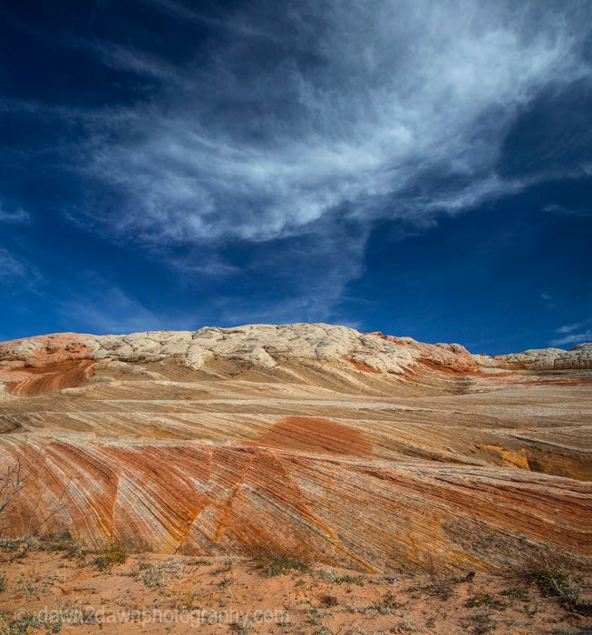 Wispy clouds hover over the sandstone anomalies at White Pocket at Vermilion Cliffs National Monument, Arizona