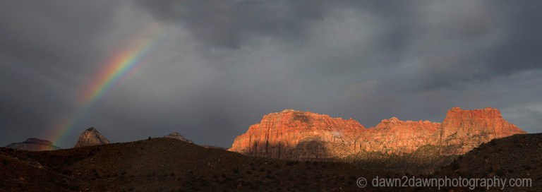 A passing thunderstorm produces a rainbow at Zion National Park, Utah