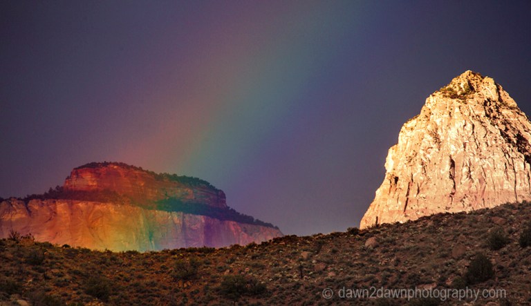 A passing thunderstorm produces a rainbow at Zion National Park, Utah