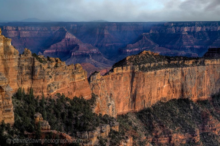 The sun sets on the Grand Canyon as seen from The North Rim at Grand Canyon National Park, Arizona