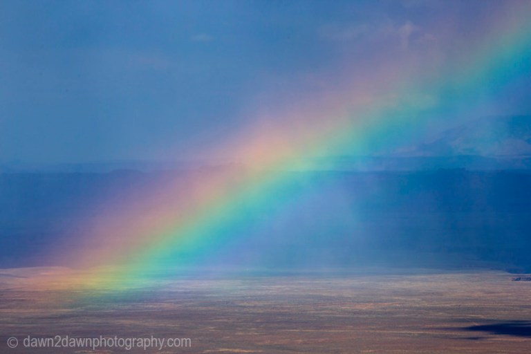 A rainbow appears during a thunderstorm at Marble Canyon at Grand Canyon National Park, Arizona.