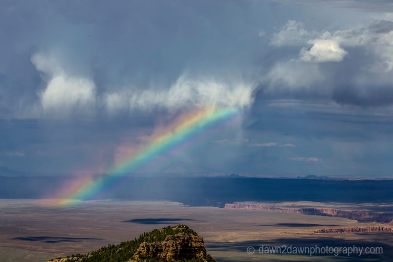 A rainbow appears during a thunderstorm at Marble Canyon at Grand Canyon National Park, Arizona.