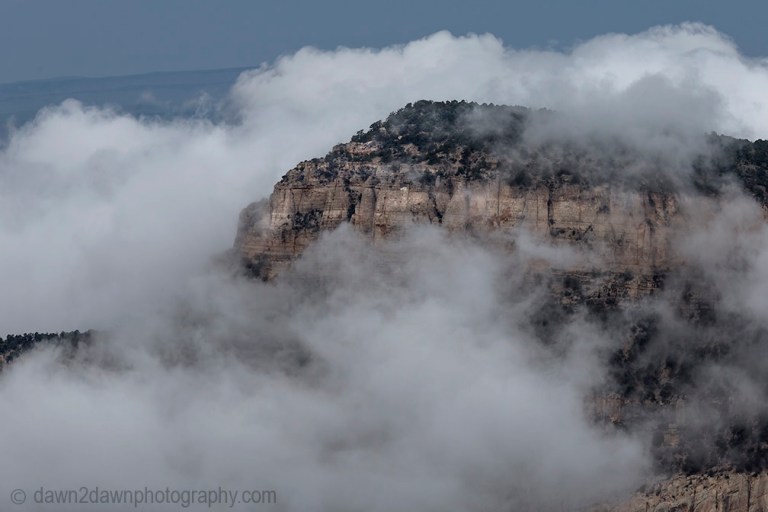 Fog rises from the bottom of the Grand Canyon at Timp Point,, Kaibab National Forest, Arizona