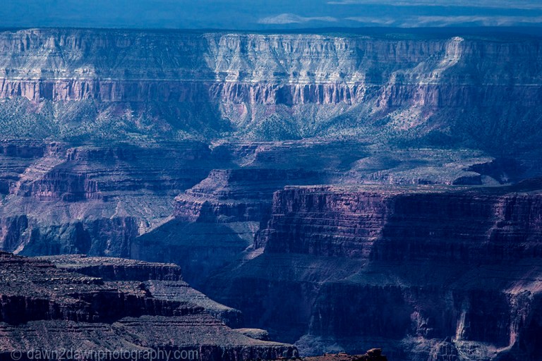 The setting sun shines some light on the Grand Canyon at Grand Canyon National Park, Arizona