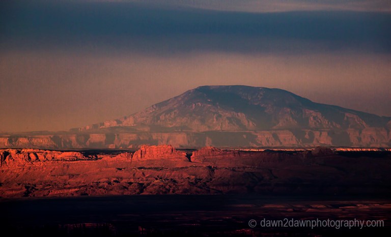 The light from the setting sun shines on Marble Canyon and Navajo Mountain at Grand Canyon National Park, Arizona.
