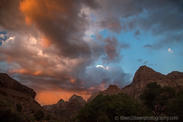 The sun sets on Zion Canyon and some stormy clouds at Zion National Park, Utah