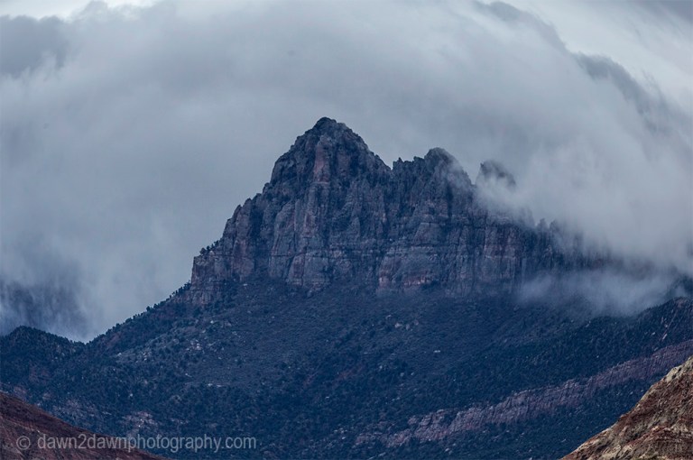 Rain clouds surround Smithsonian Butte near Zion National Park, Utah