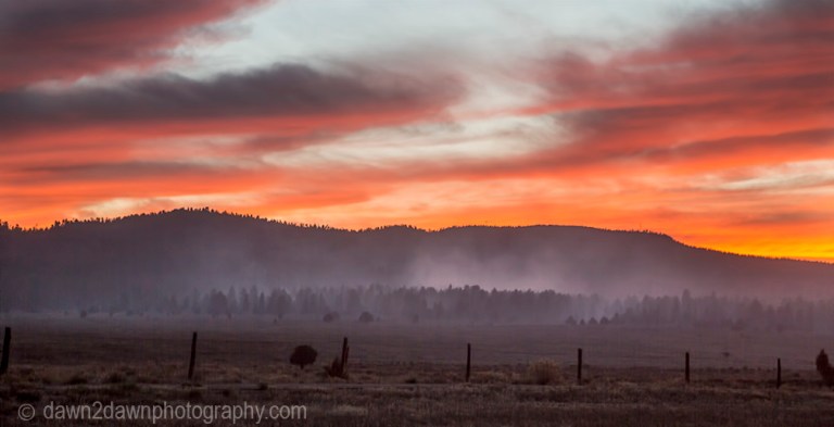 The sun sets amongst a brush fire in rural Utah.