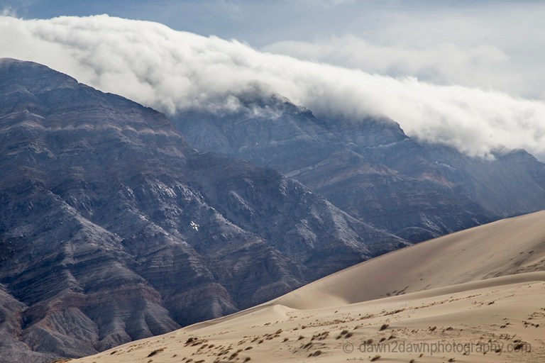A fighter jet from nearby China Lake Naval Air Warfare Center flies over Death Valley National Park, California