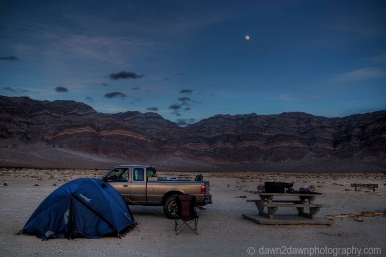 A nearly full moon rises over the Last Chance Mountains at Death Valley National Park, California