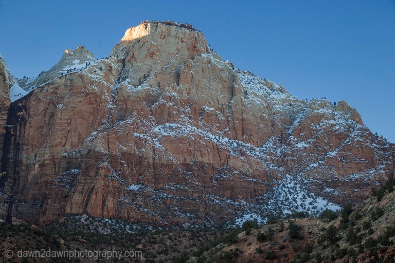 The light from the setting sun shines on Zion Canyon during winter at Zion National Park, Utah