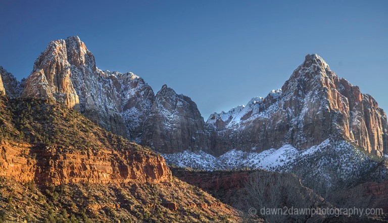 The light from the setting sun shines on Zion Canyon during winter at Zion National Park, Utah