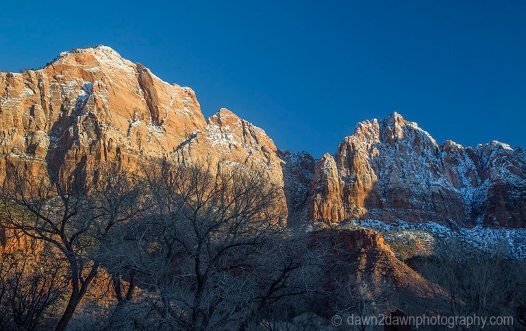 The light from the setting sun shines on Zion Canyon during winter at Zion National Park, Utah